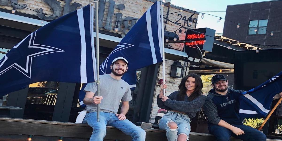 fans holding Cowboys flags