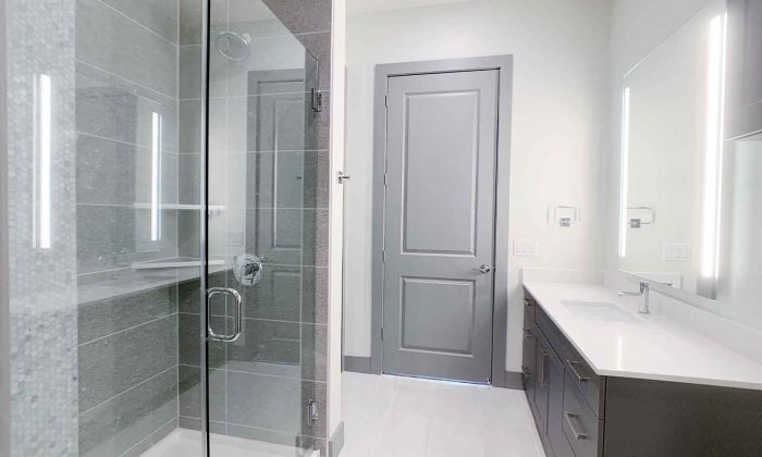 Luxury apartment bathroom with glass standing shower