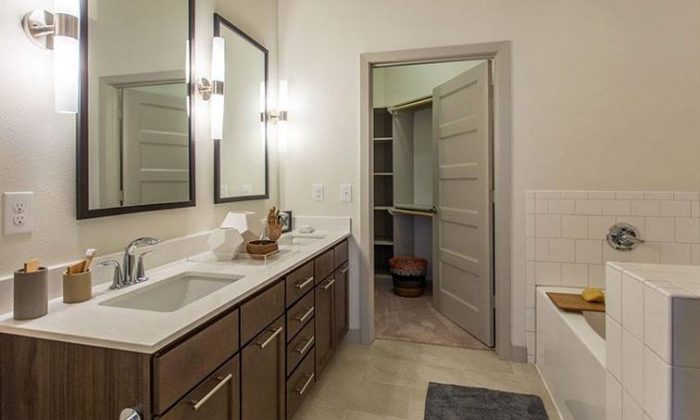 apartment bathroom with dual vanity