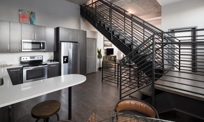 luxury split-level apartment kitchen and wrapping staircase