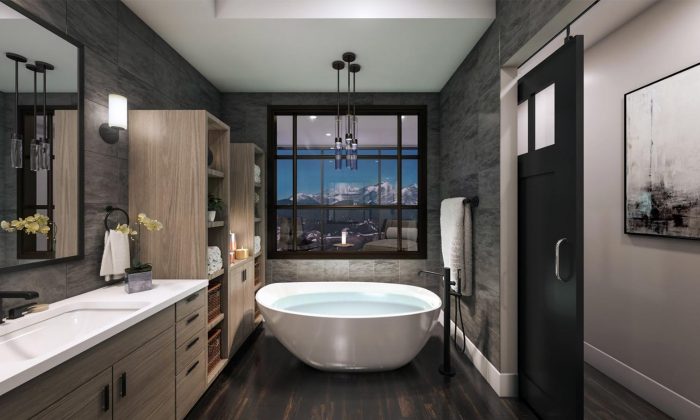 luxury apartment bathroom with large white bathtub near window with downtown views