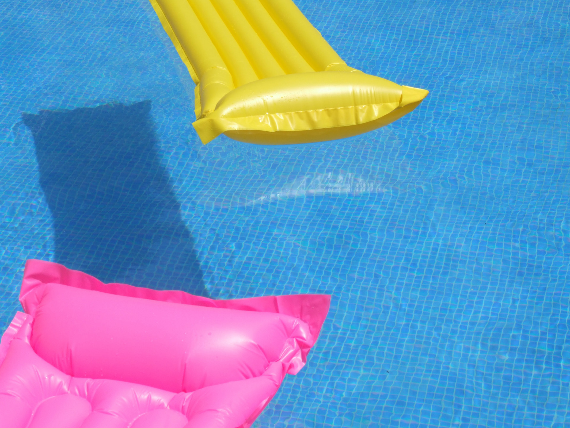 Pool with colorful inflatable lounge floats