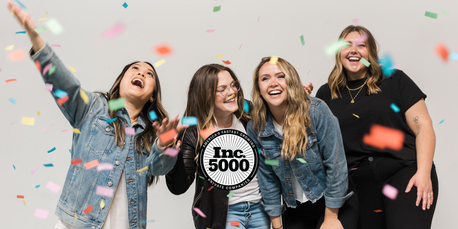 Smart City team playing in confetti with inc 5000 badge