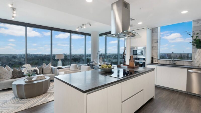 Luxury apartment kitchen overlooking floor-to-ceiling windows