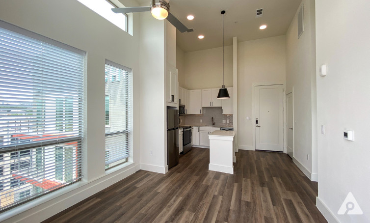 downtown austin apartment with white finishes wood floors and high ceiling