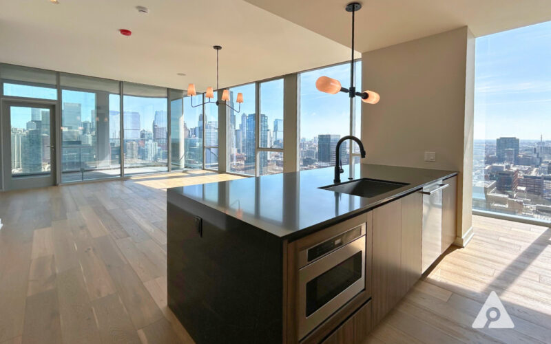 Kitchen island and living room with a city view