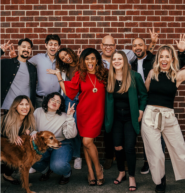 a group of people posing for a photo with a dog