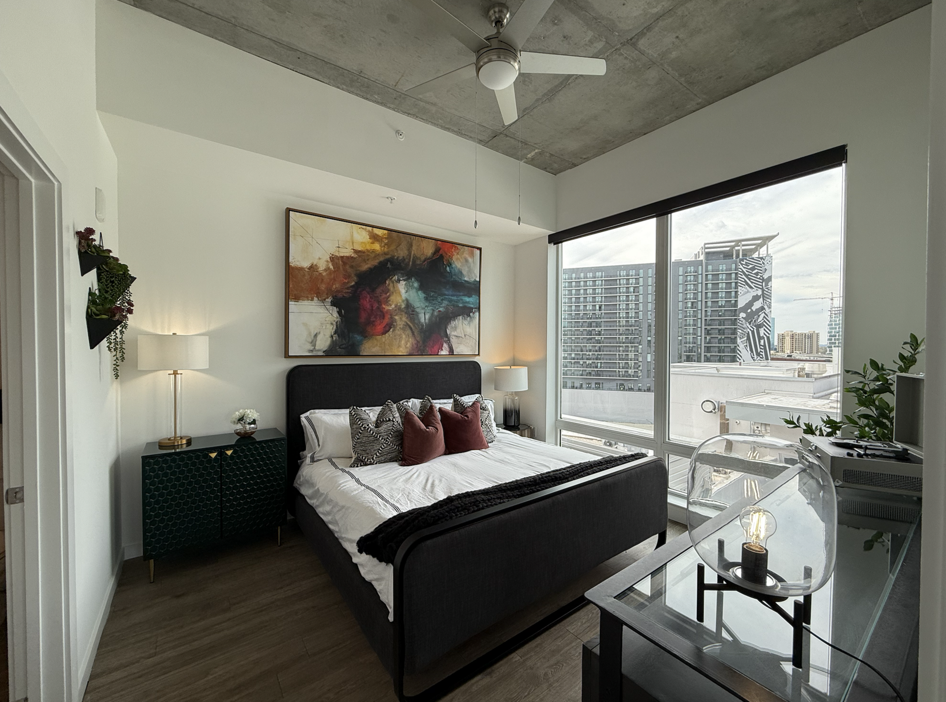 Nashville apartment bedroom with zero carpet and floor to ceiling windows.