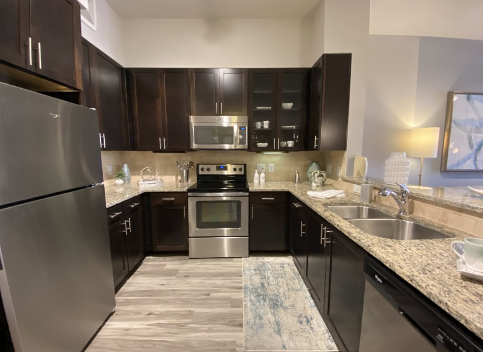 Atlanta apartment kitchen with maple cabinetry, stainless steel appliances, and plenty of counter space.