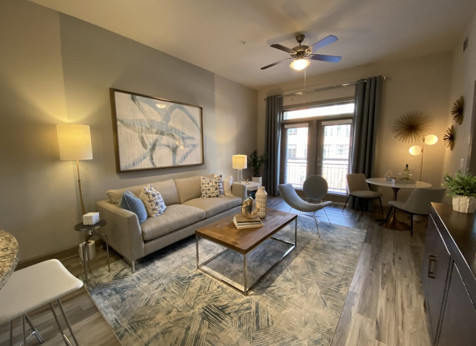 Spacious living room in Buckhead apartment with tons of natural light and an attached balcony.