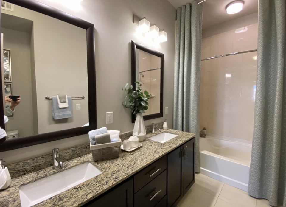 Atlanta apartment bathroom with dual vanity sinks.