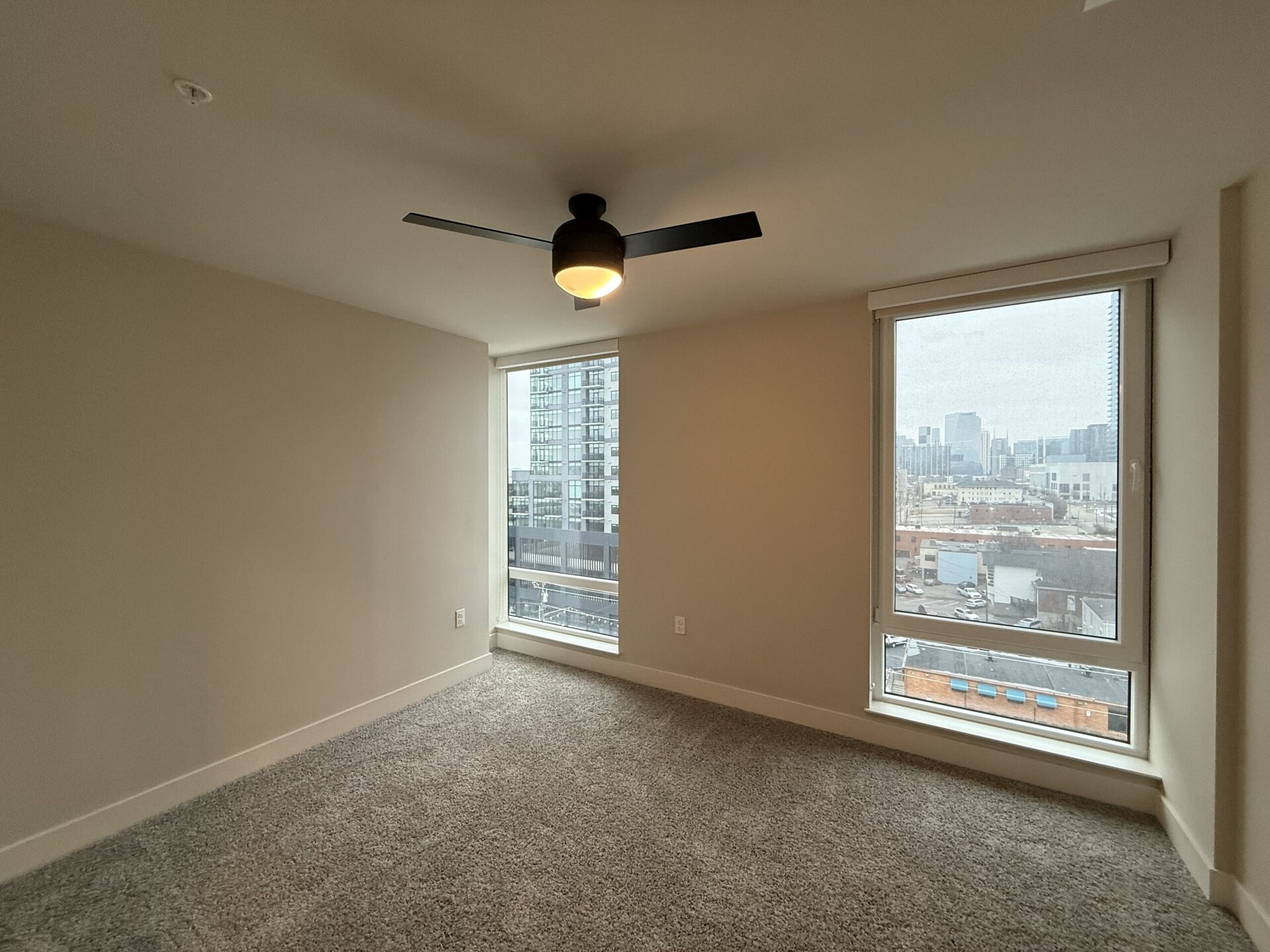Nashville Midtown apartment bedroom with floor to ceiling windows.