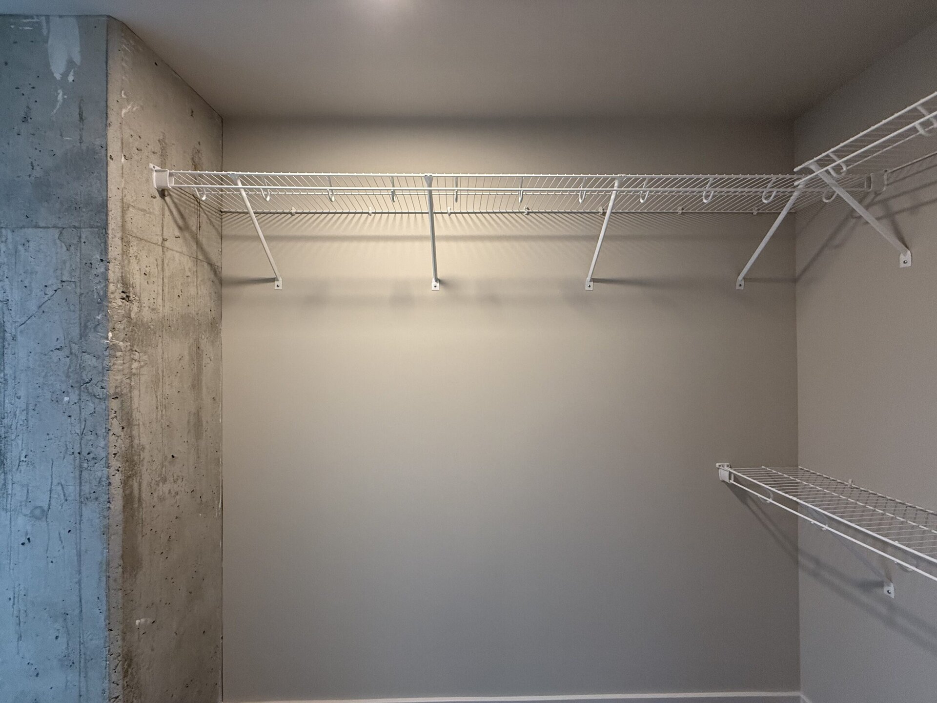 Nashville Midtown apartment walk in closet with a window.