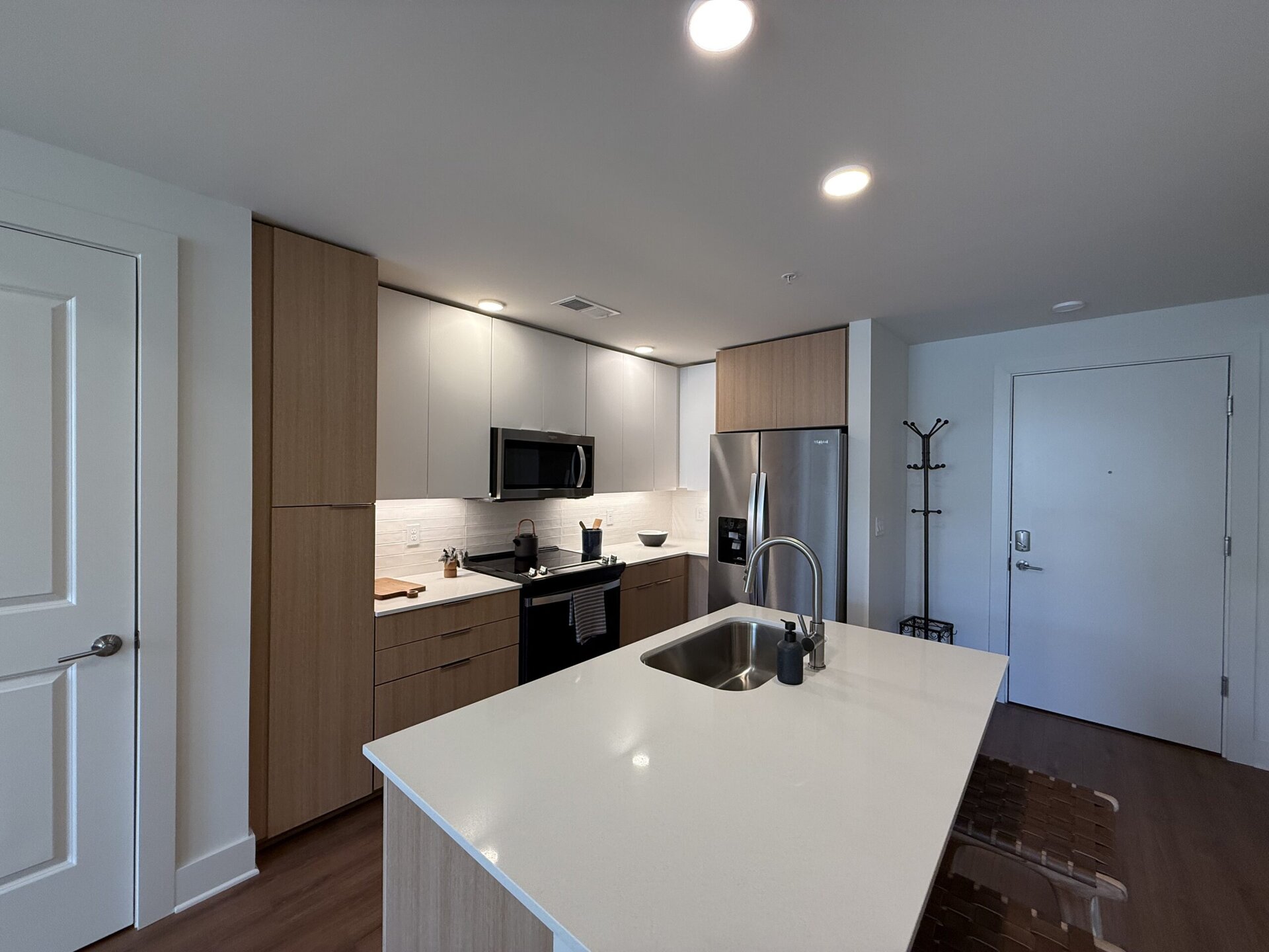 Germantown apartment kitchen with two tones cabinets and a large island.