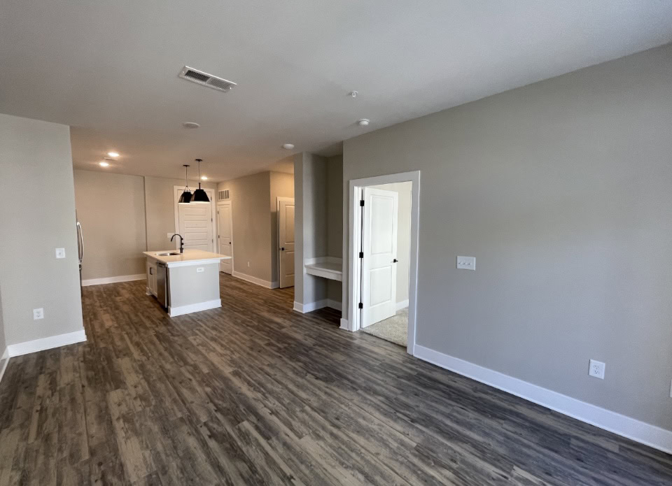 Upper Westside apartment living room with hardwood floors, natural lighting, and an attached balcony.