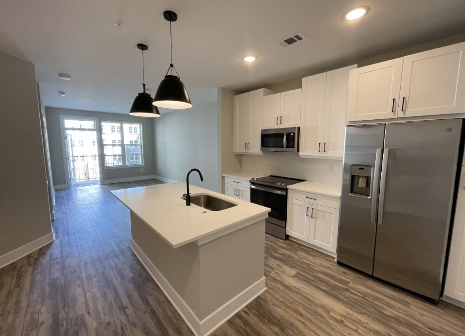Upper Westside apartment kitchen with white cabinets and stainless steel appliances.