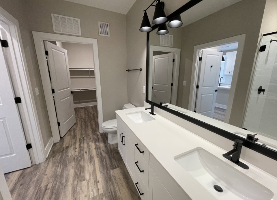 Upper Westside apartment bathroom with dual vanity sinks and attached closet.