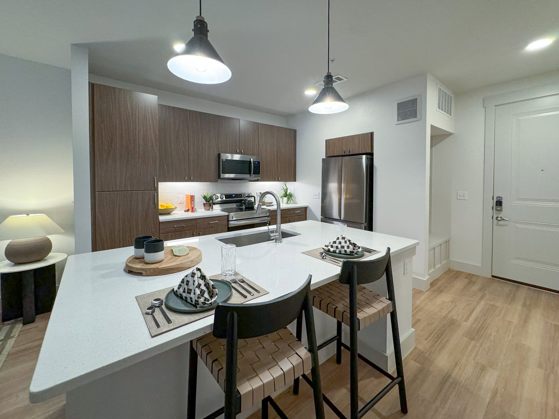 apartment kitchen with island and stainless steel appliances