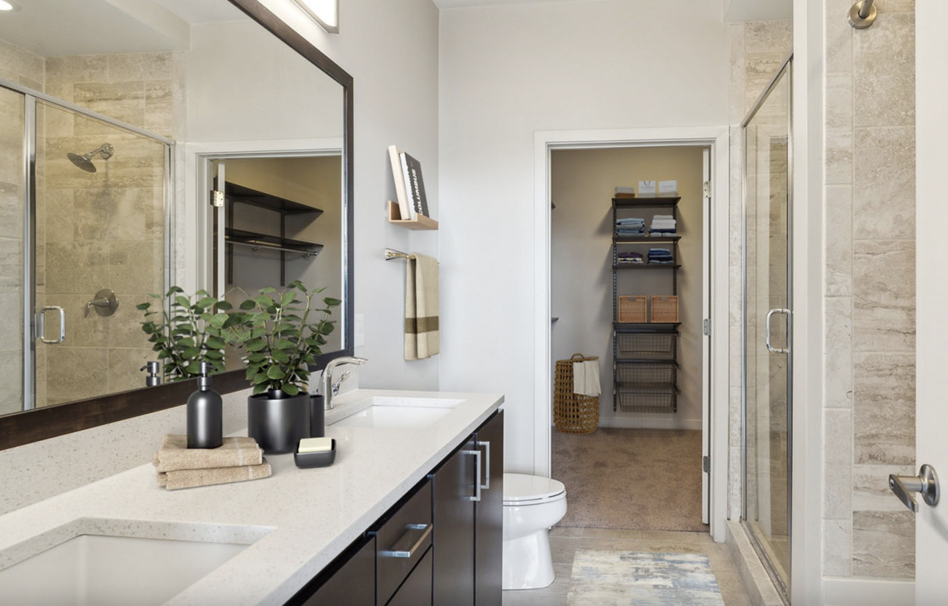 Midtown Atlanta apartment bathroom with dual vanity sinks and a walk in shower.