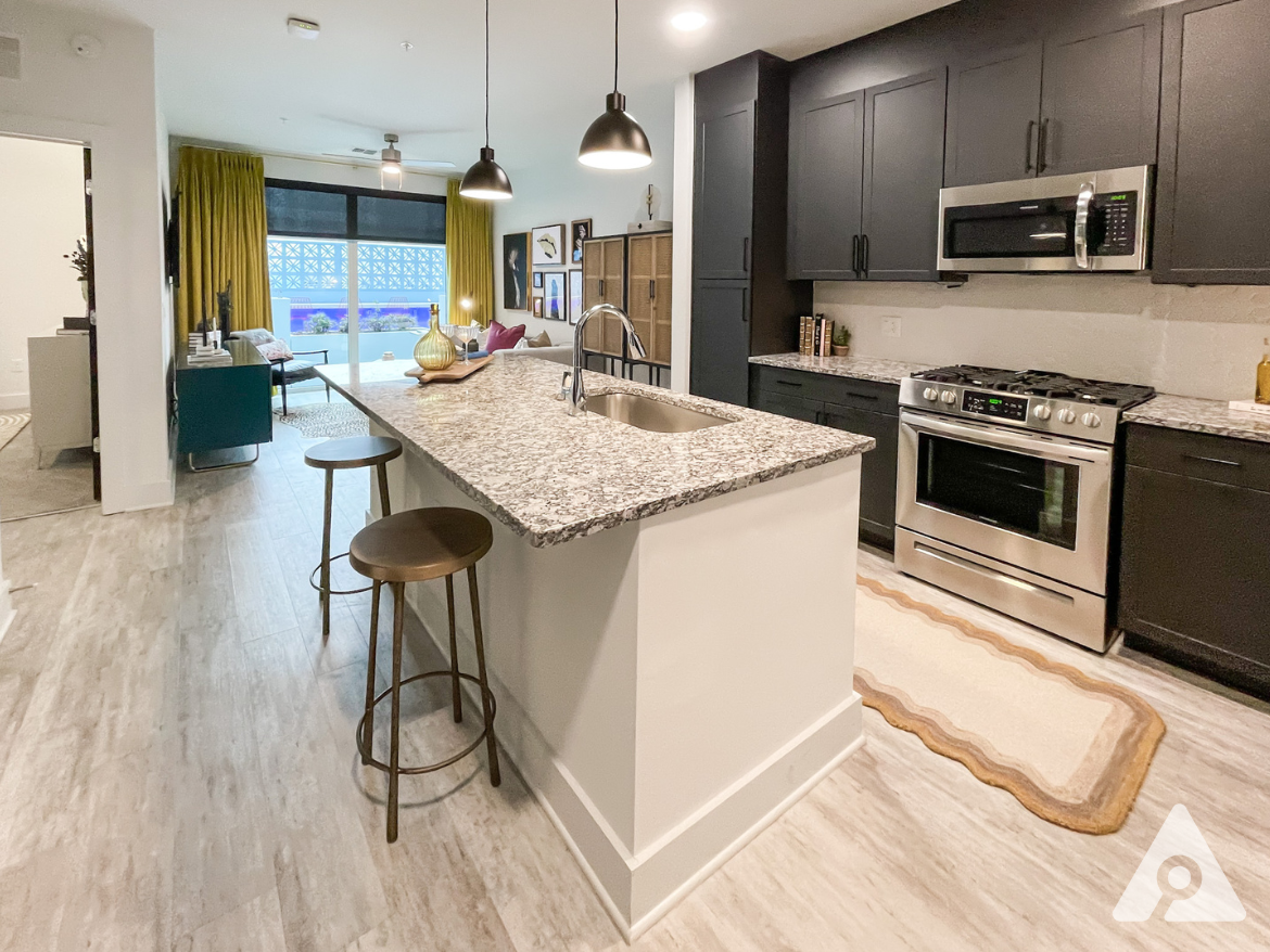 Midtown Atlanta apartment kitchen with an island and dark cabinets.