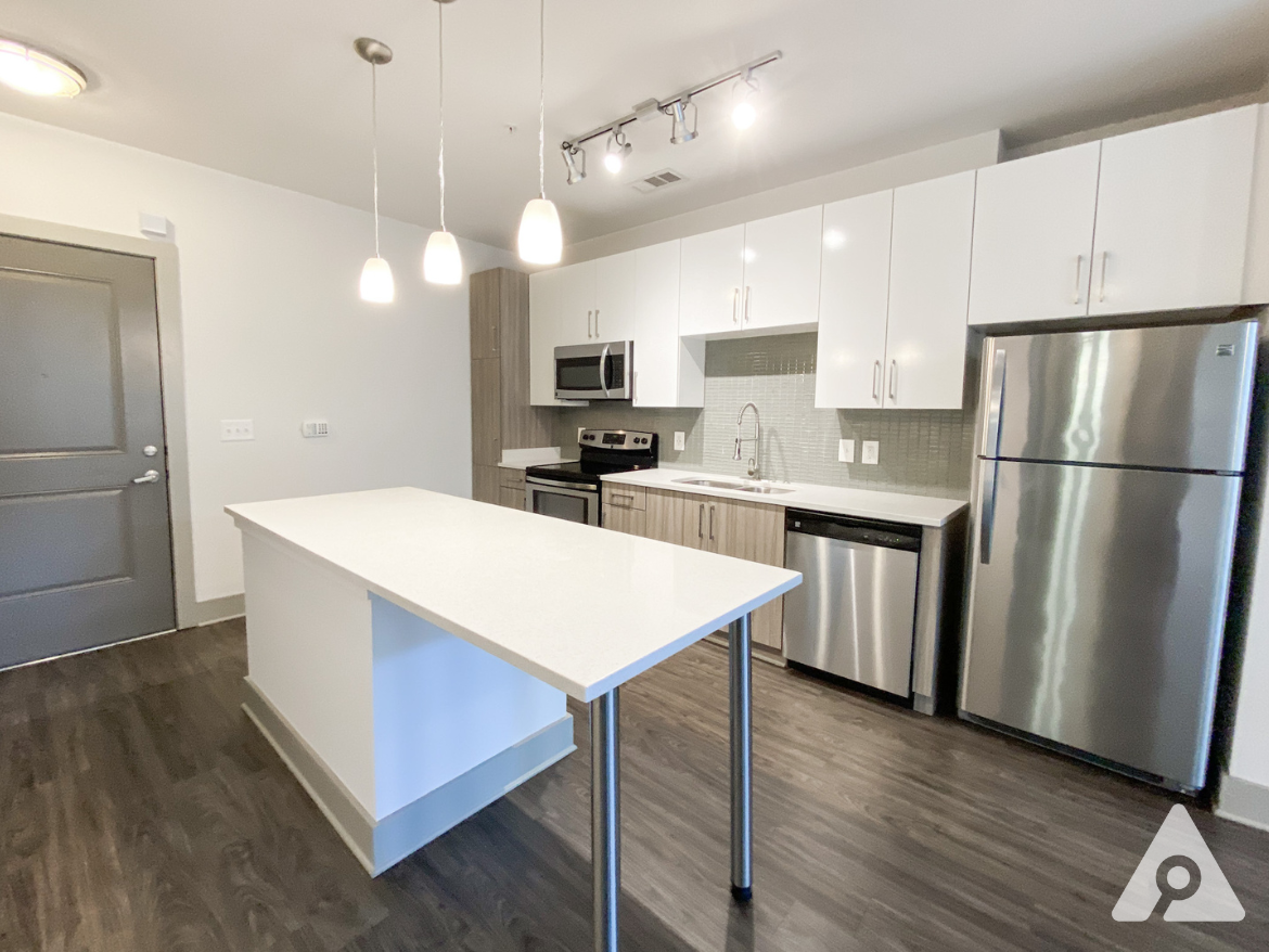 West Midtown Atlanta apartment kitchen with bright, light finishes and updated appliances.