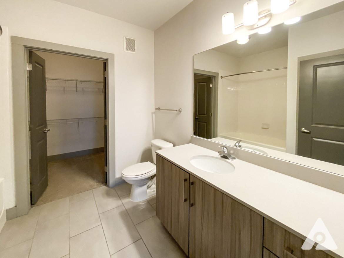West Midtown Atlanta apartment bathroom with attached walk in closet and tons of storage space.