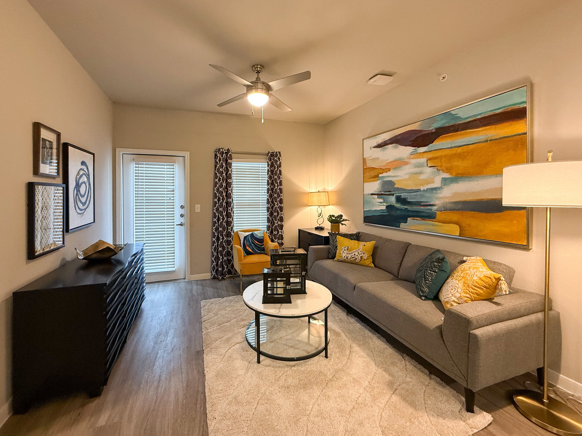 A cozy living room with natural sunlight and wood flooring