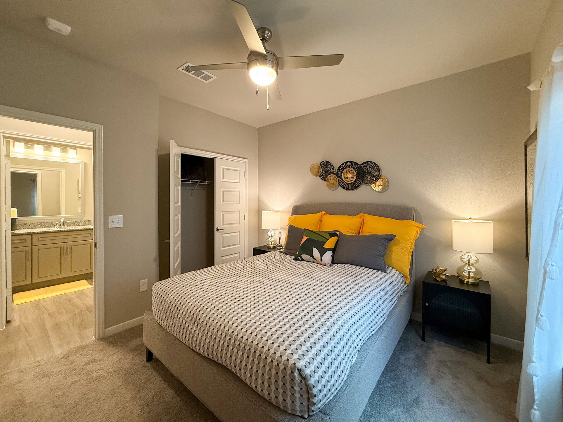 A cozy bedroom features natural sunlight with side closet.