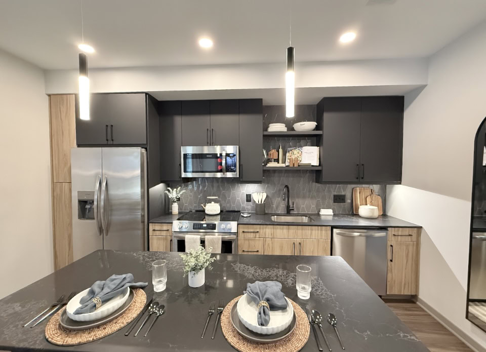 Downtown Nashville apartment kitchen with black & light wood cabinets.