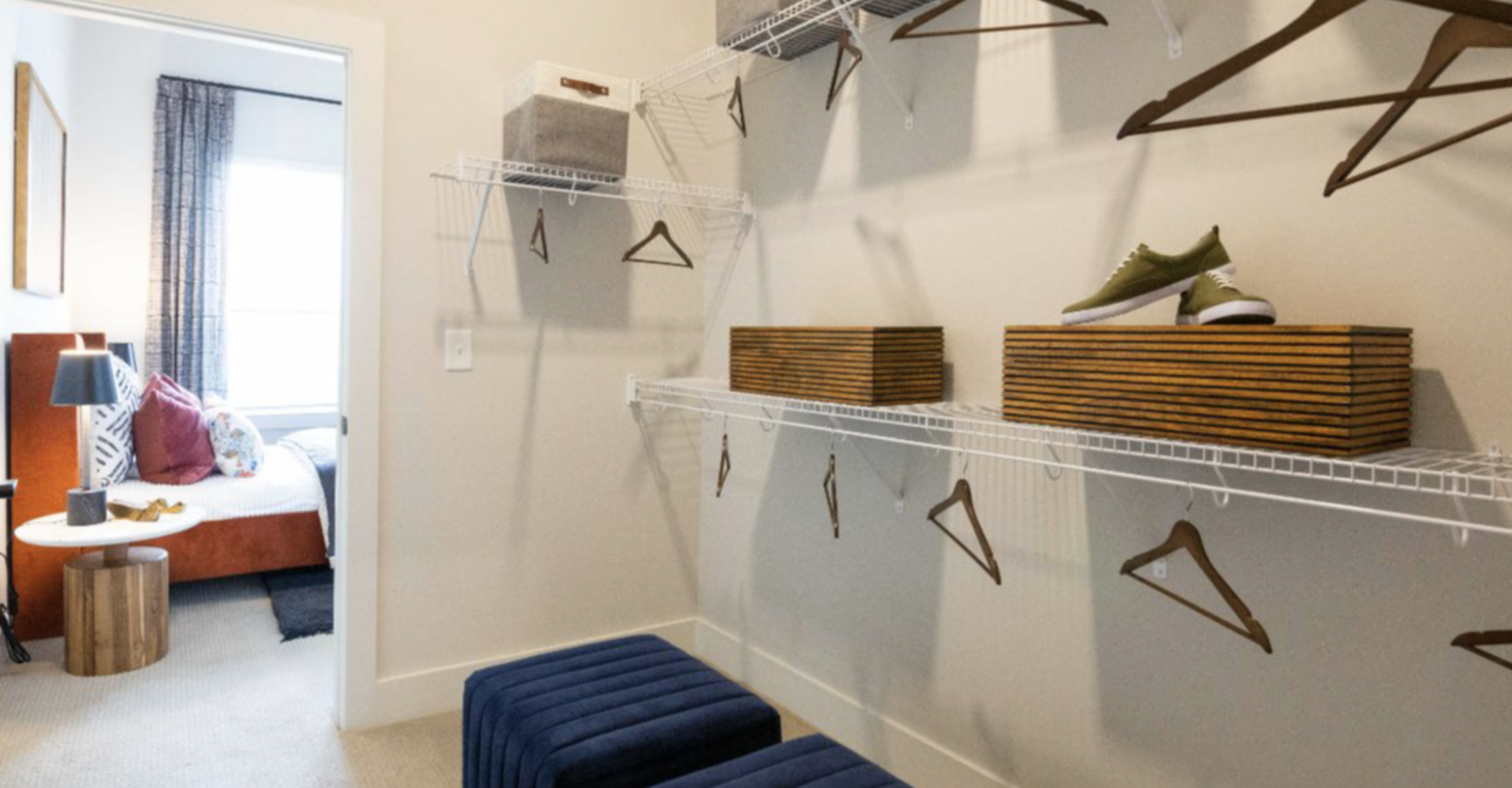 Decatur apartment walk in closet with white wire organization racks.
