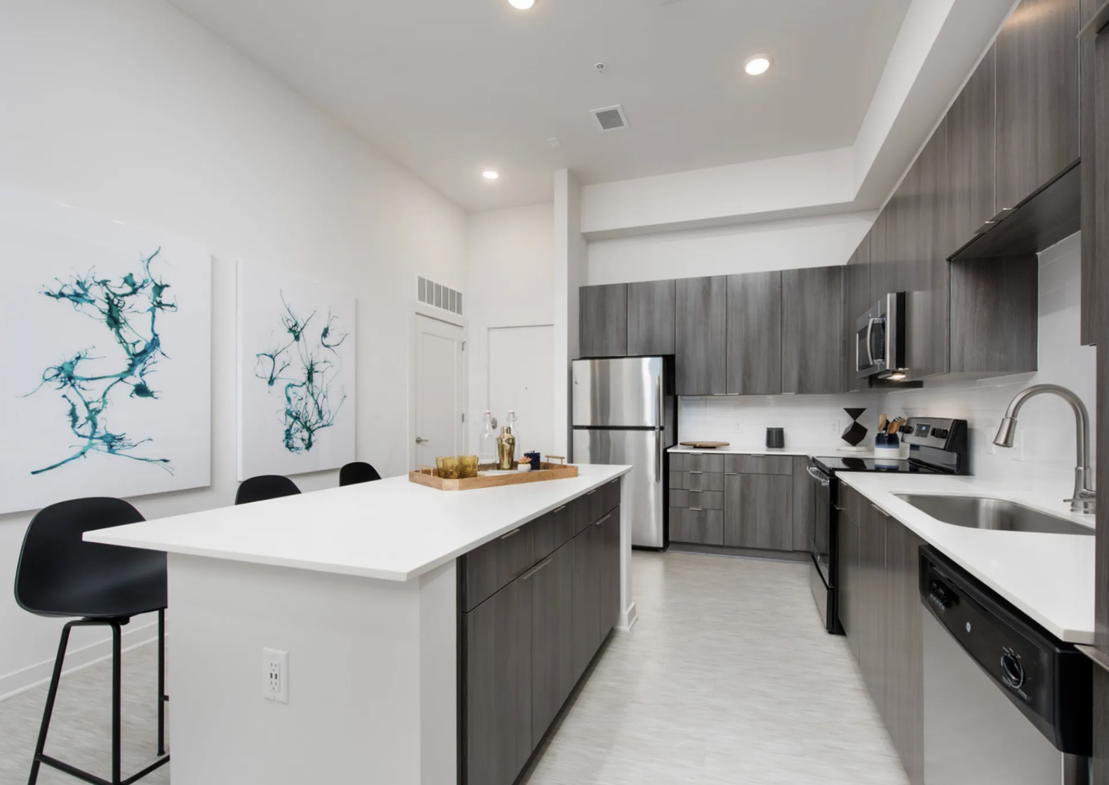 Midtown Atlanta apartment kitchen with dark wood cabinets and an oversized kitchen island.
