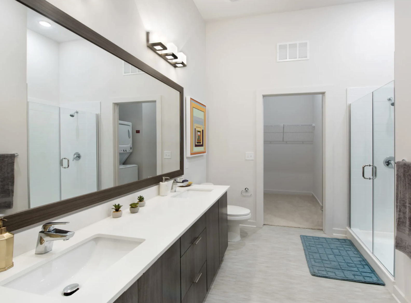 Midtown Atlanta apartment bathroom with dual vanity sinks and a shower.