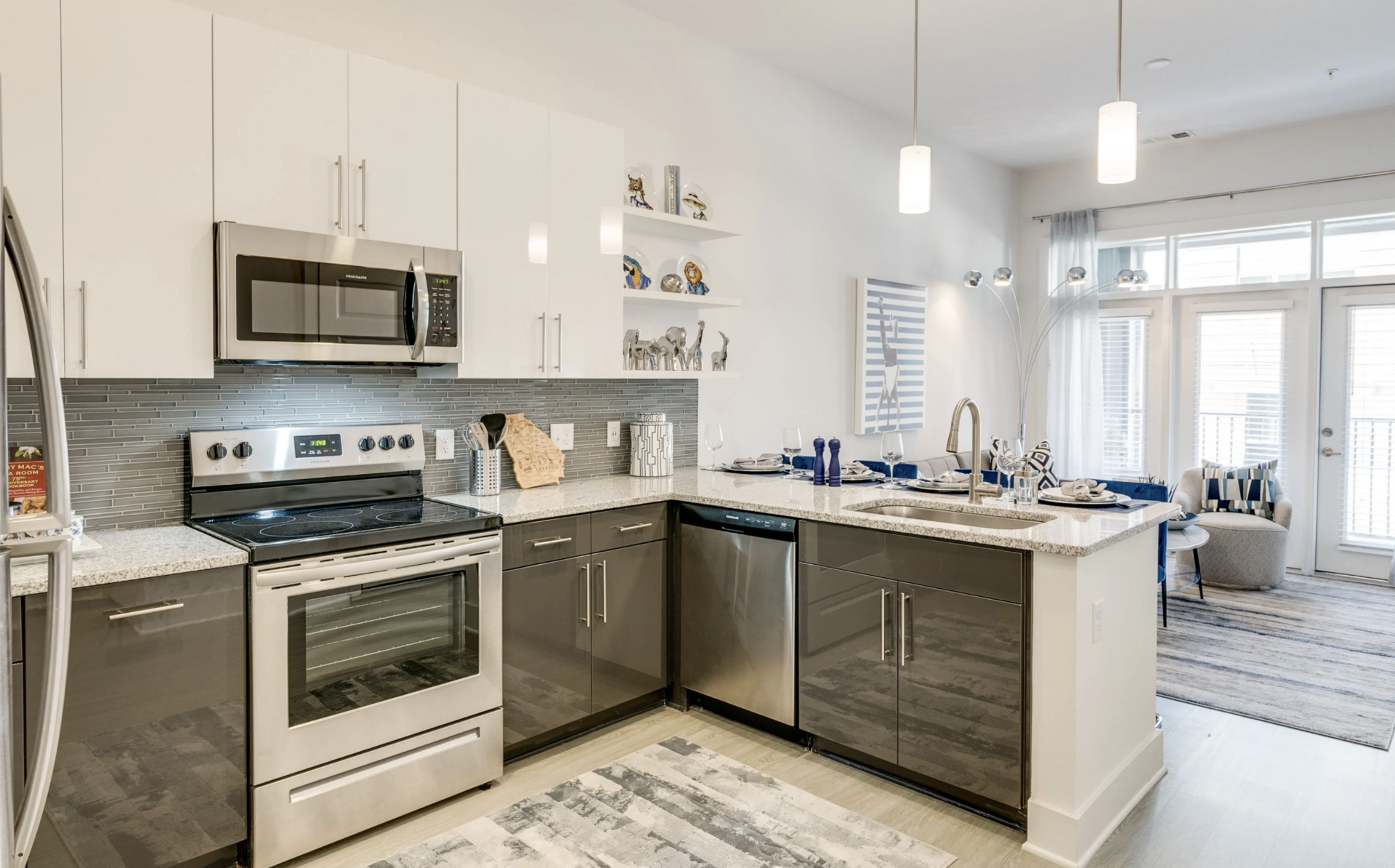 Grant Park apartment kitchen with white & grey cabinets and stainless steel appliances.