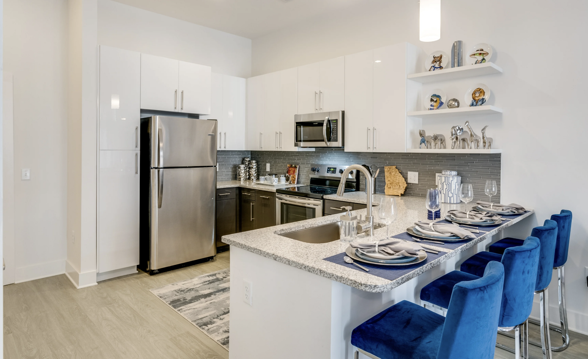 Grant Park apartment kitchen with an L shaped countertop, tons of storage space, and modern clean finishes.