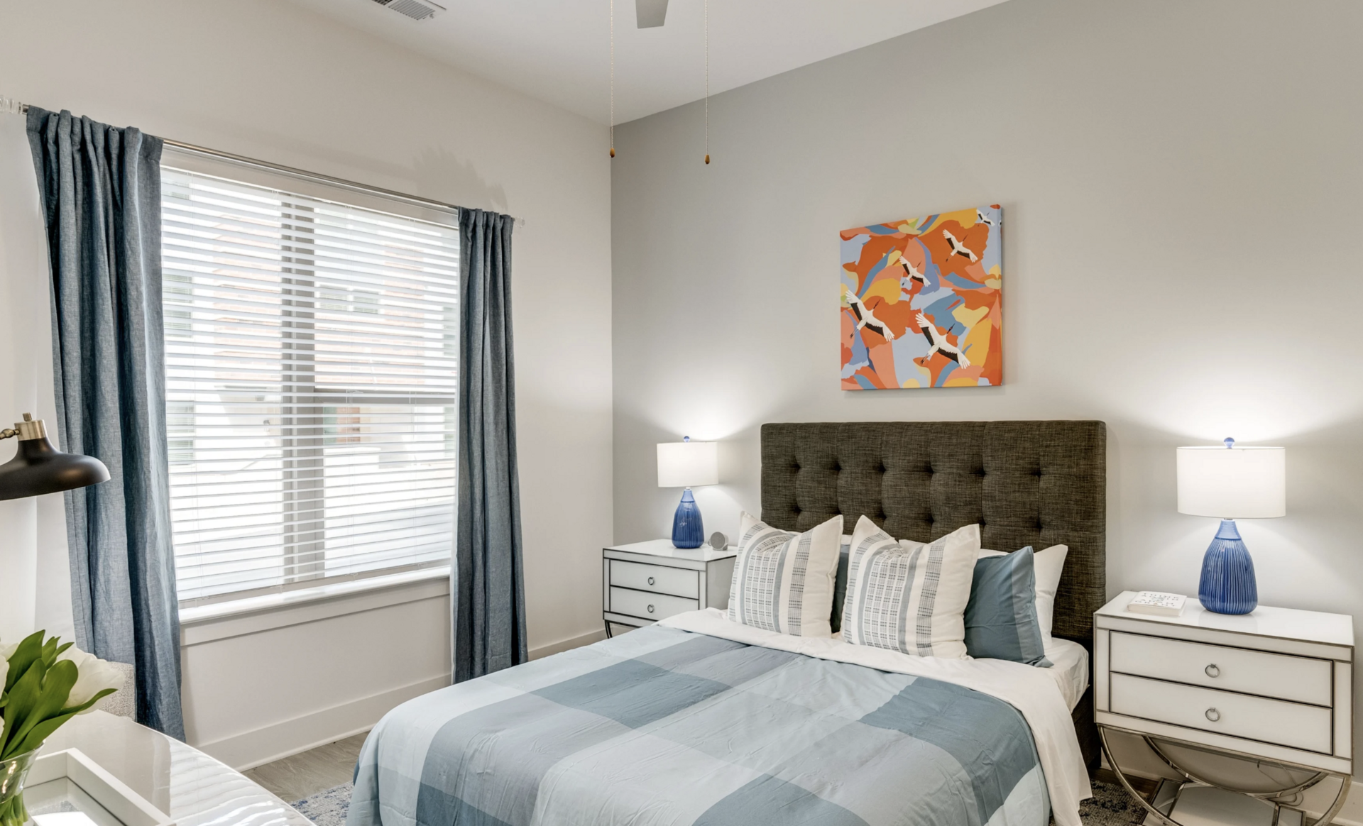 Grant Park apartment bedroom with tall ceilings and carpeted floors.