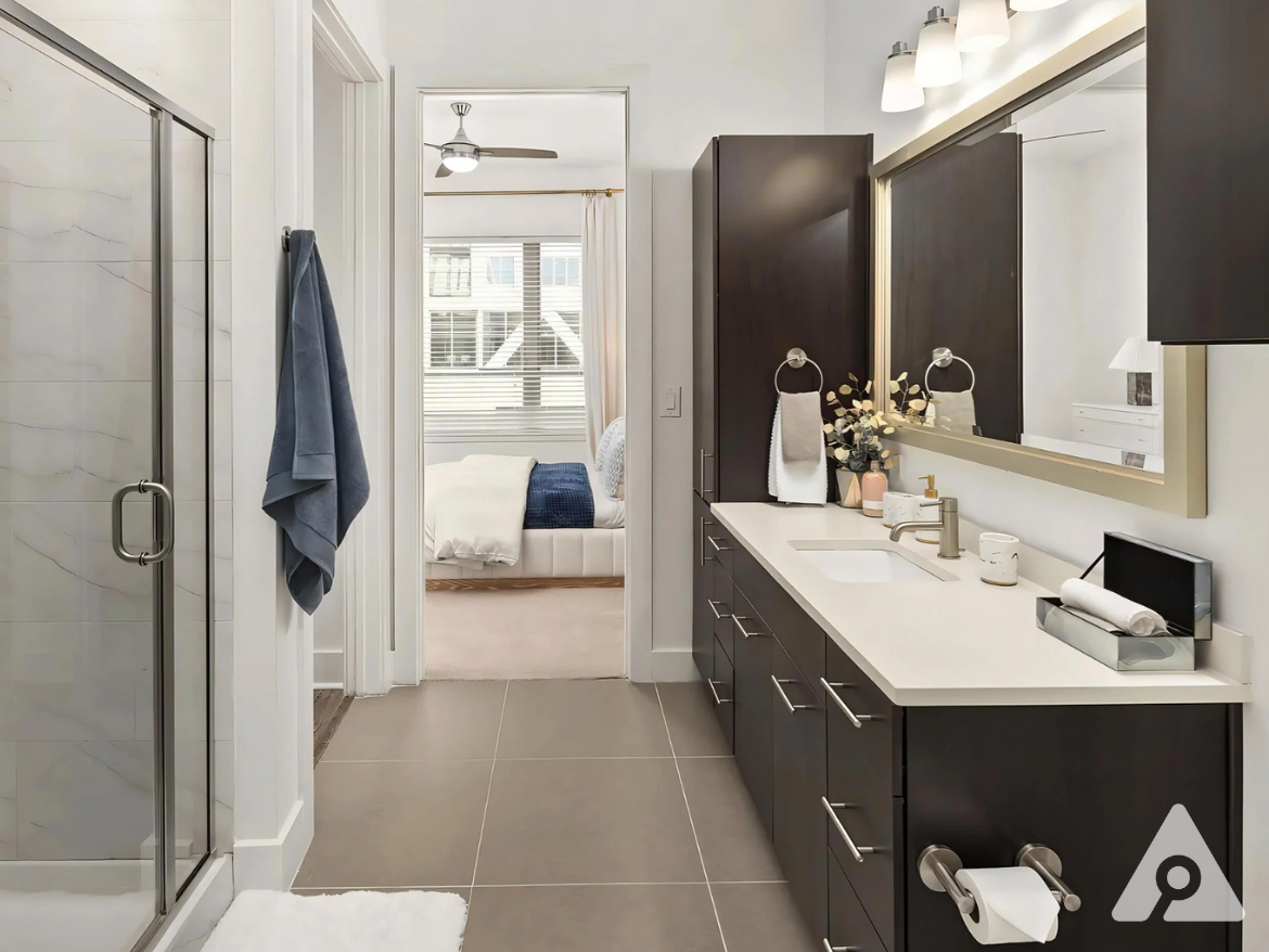 Midtown Atlanta Apartment bathroom with tone of cabinet space and a walk-in shower.