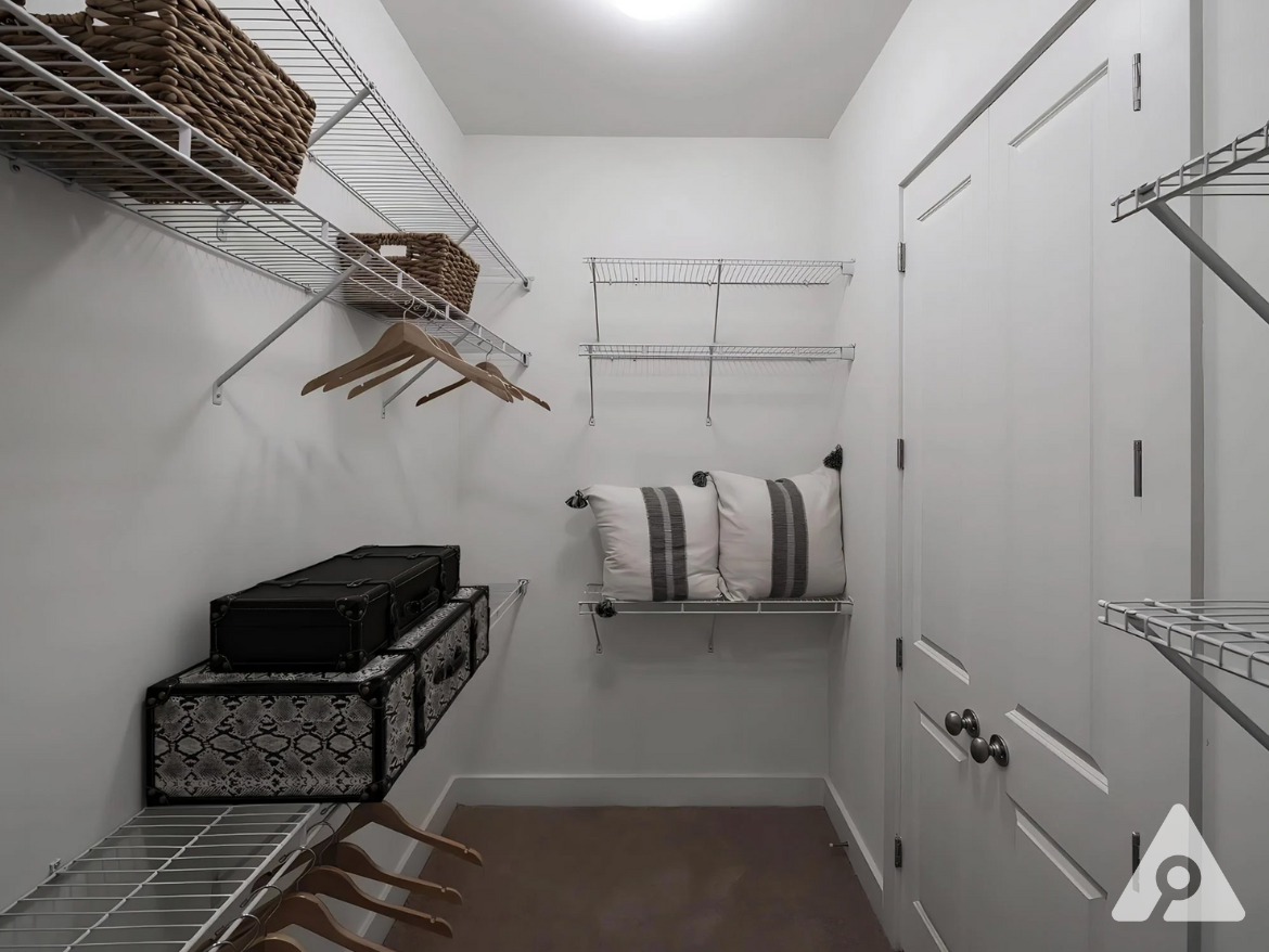 Midtown Atlanta apartment walk in closet with organization racks.