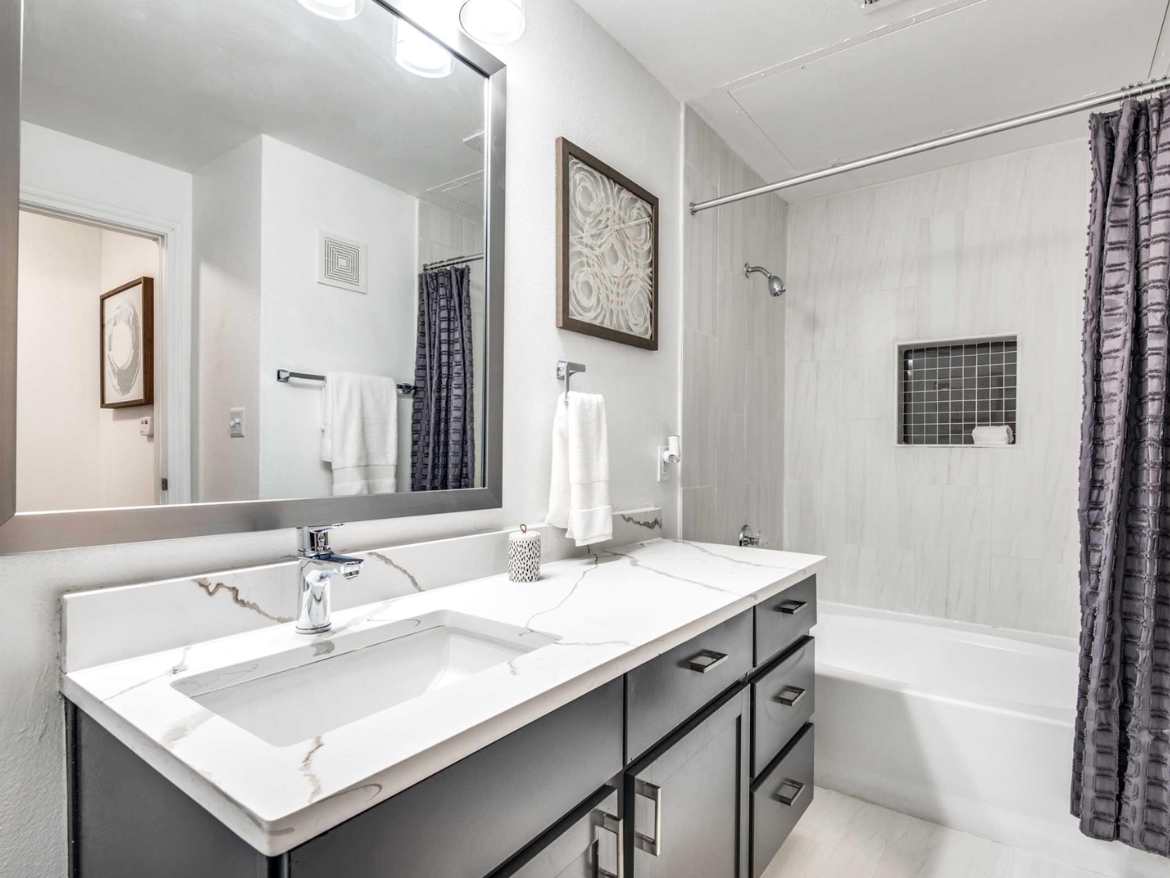 Dallas apartment bathroom with spacious vanity and tub shower