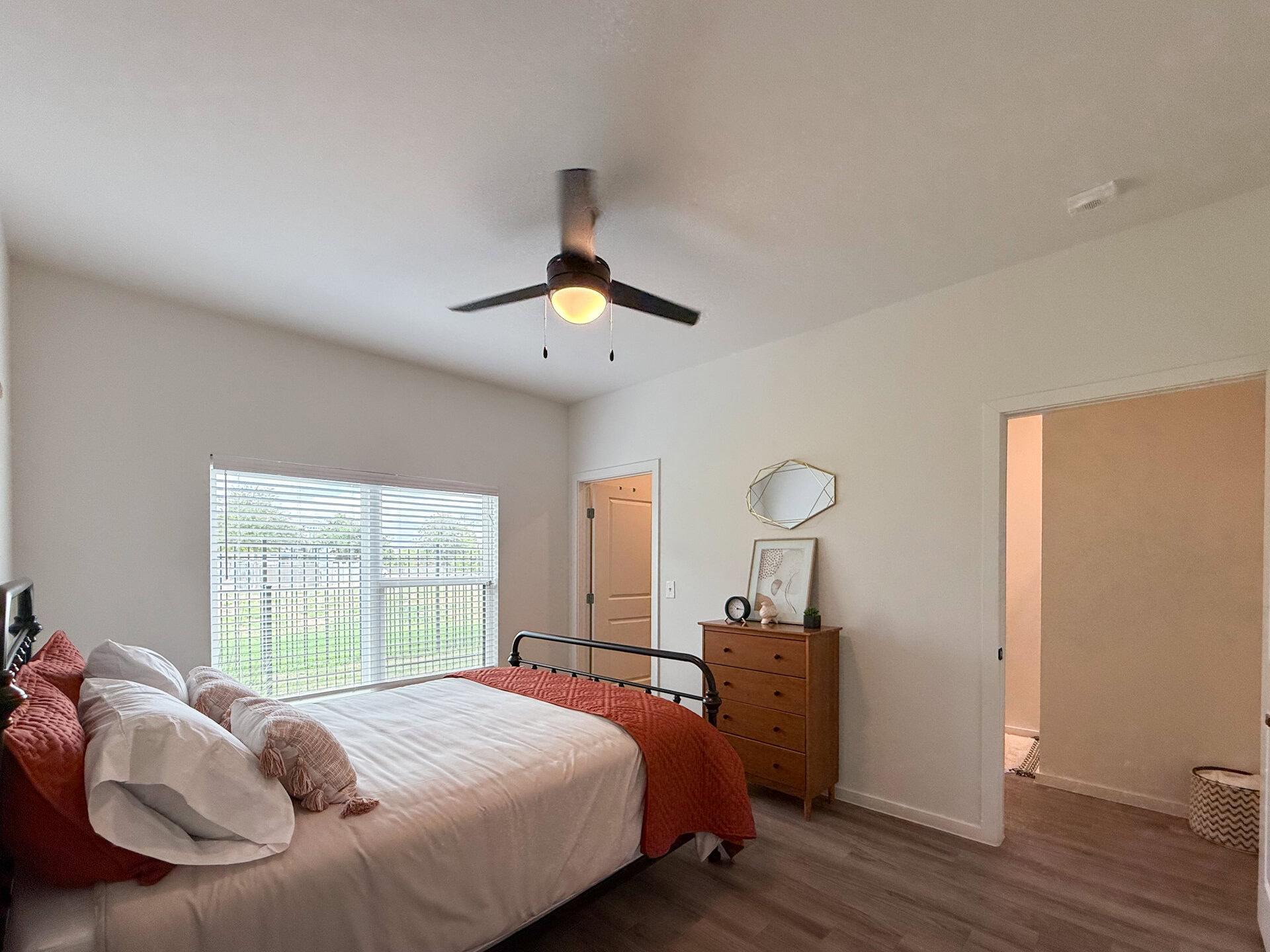 A cozy bedroom features ample natural light & space.
