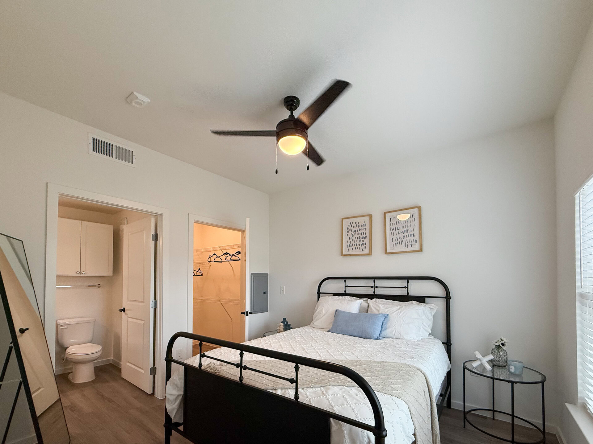 A cozy bedroom features ample natural light & space.