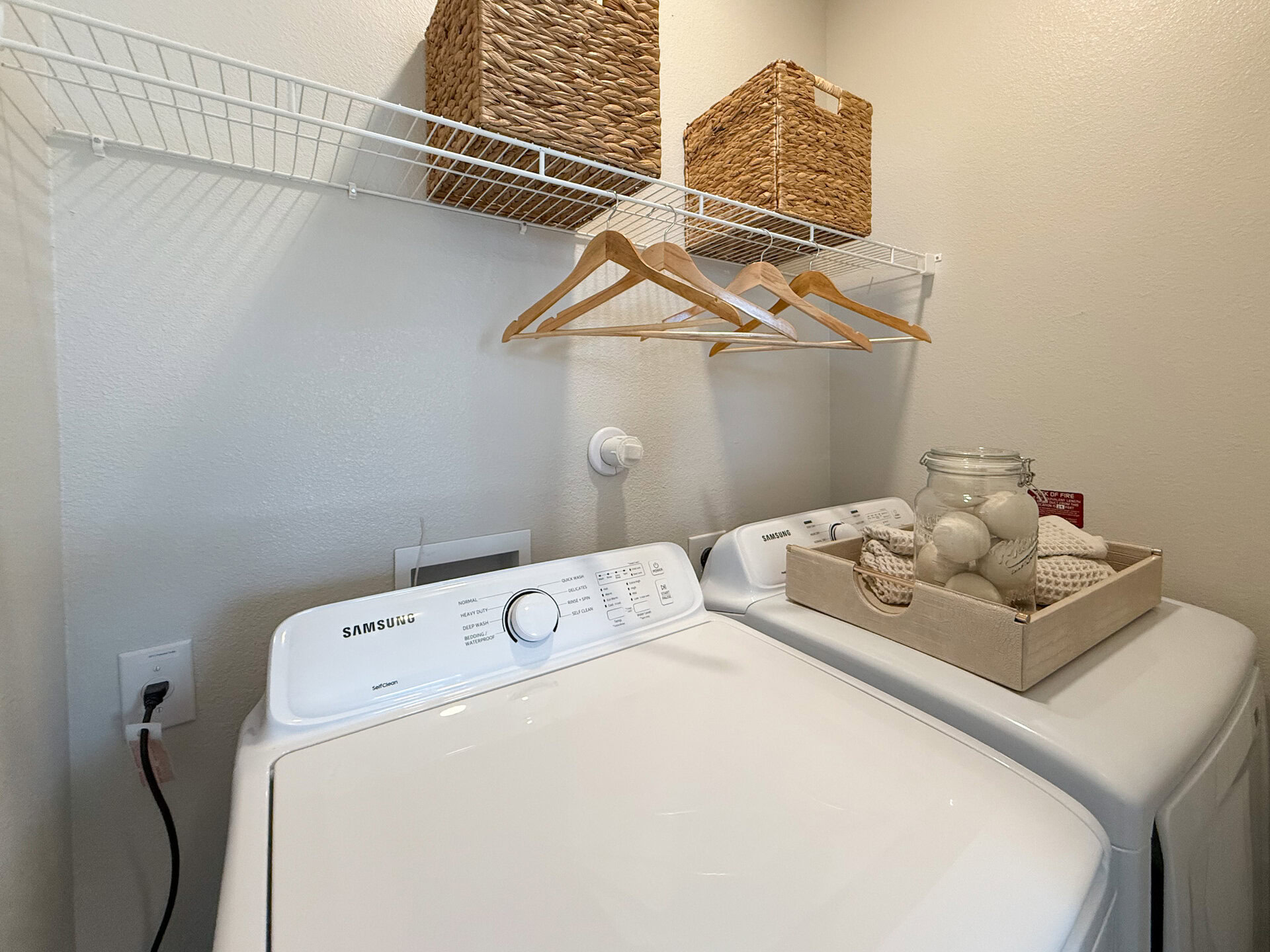 Samsung washer and dryer with storage above.