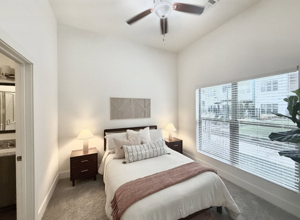 East Nashville apartment bedroom with high ceilings and a large window.