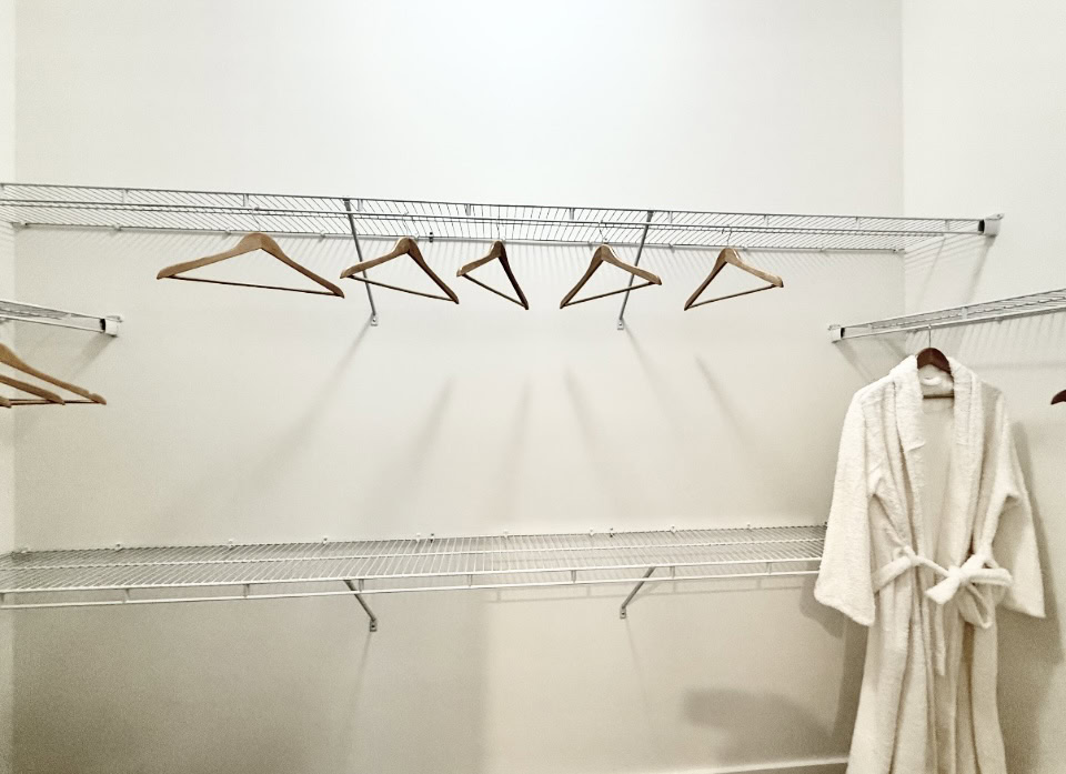 East Nashville apartment walk-in closet with organization racks.