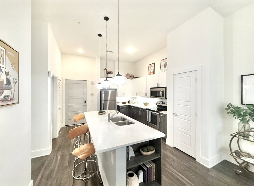 East Nashville apartment kitchen with two toned cabinets, stainless steel appliances, and a large kitchen island.