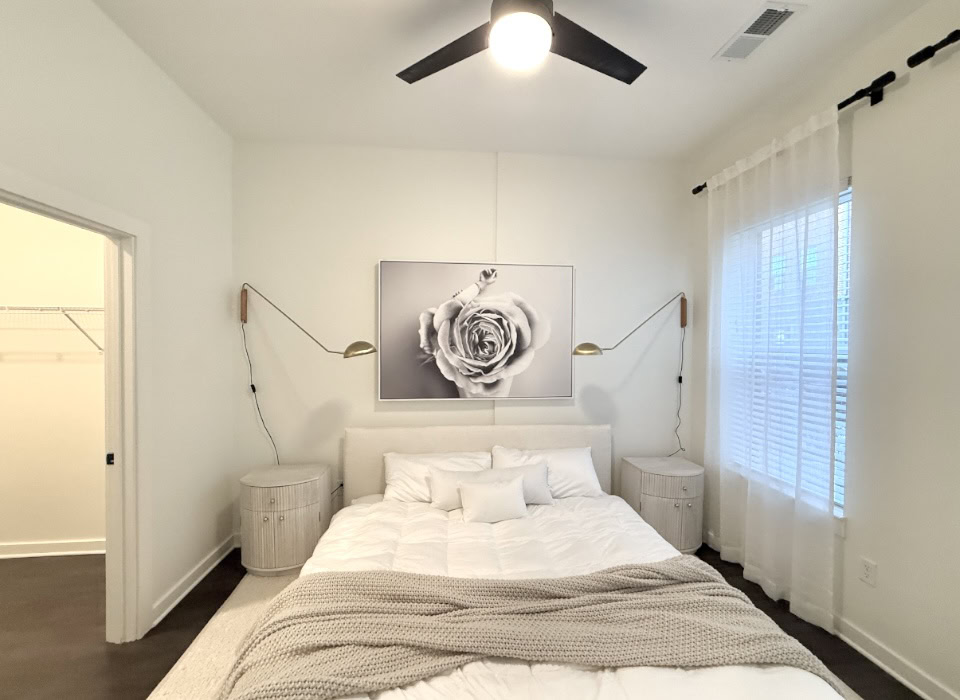 Germantown apartment bedroom with a large window and ceiling fan