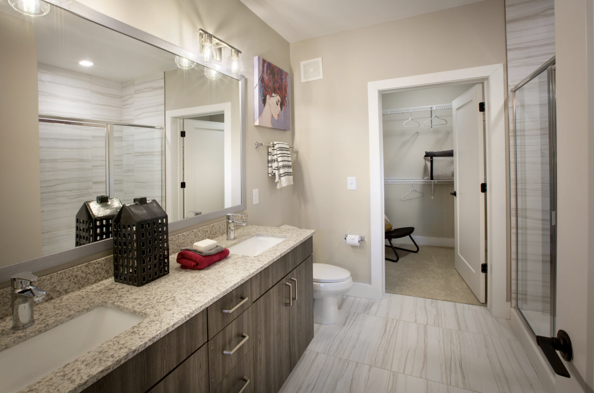 Grant Park apartment bathroom with double vanities and a connected a walk in closet.