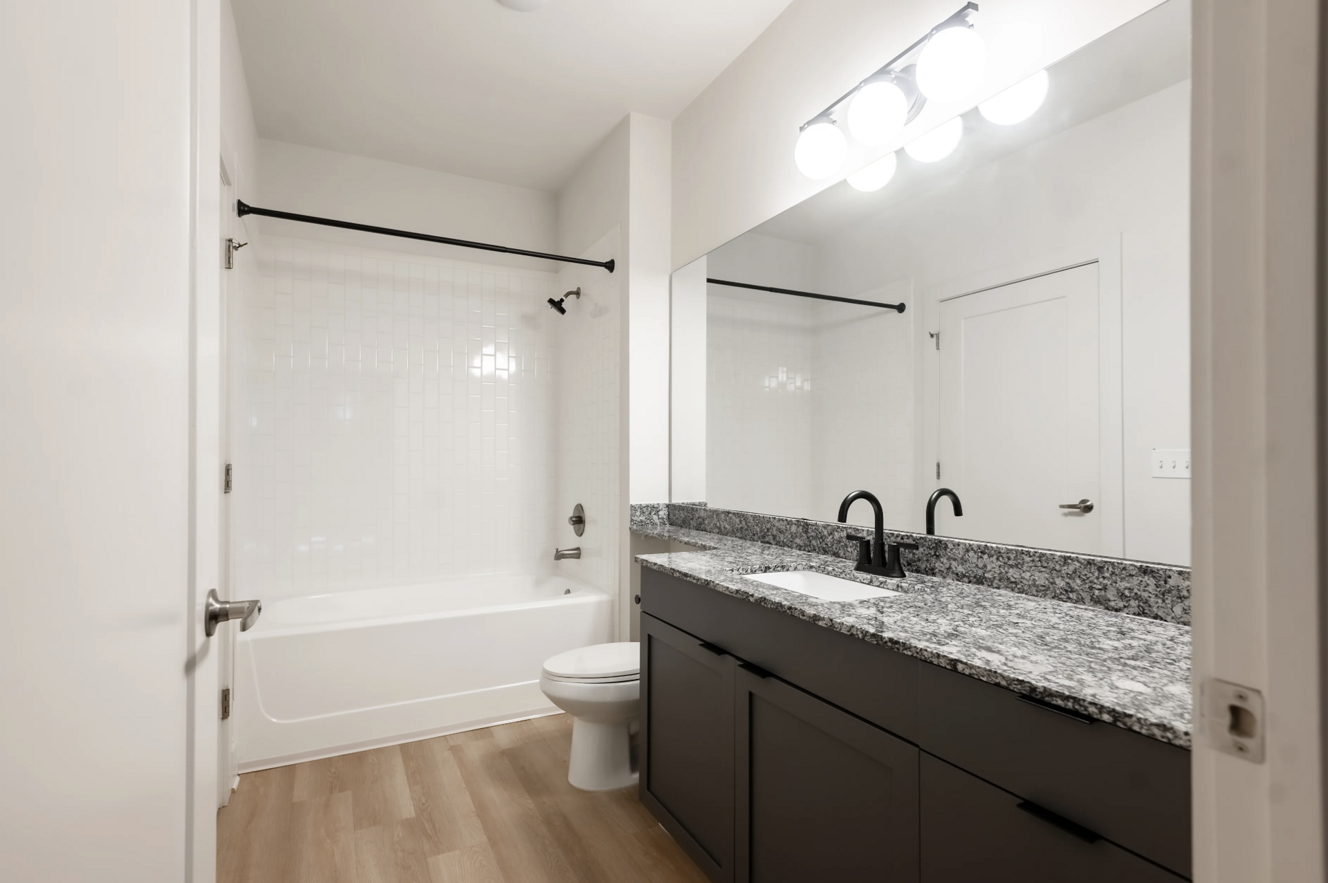 West Midtown Apartment bathroom with tons of storage and counter space, and a bath tub.
