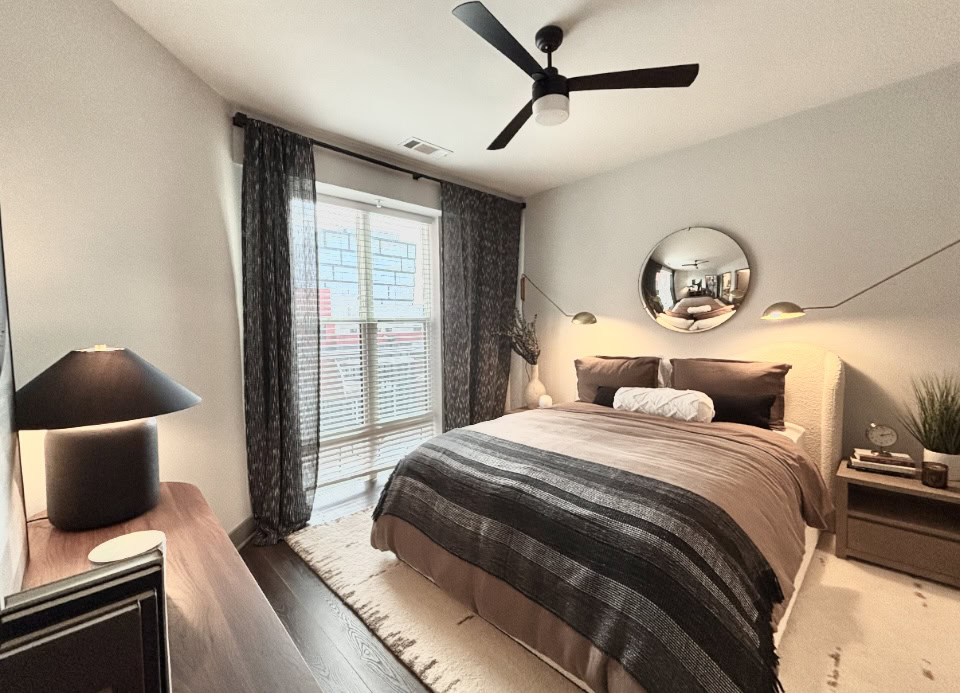 Apartments in Germantown, bedroom with a large window and wood floors.
