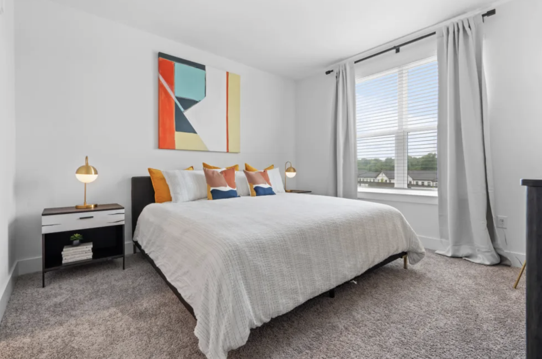 Apartments in Grant Park, bedroom with carpet and a large window.