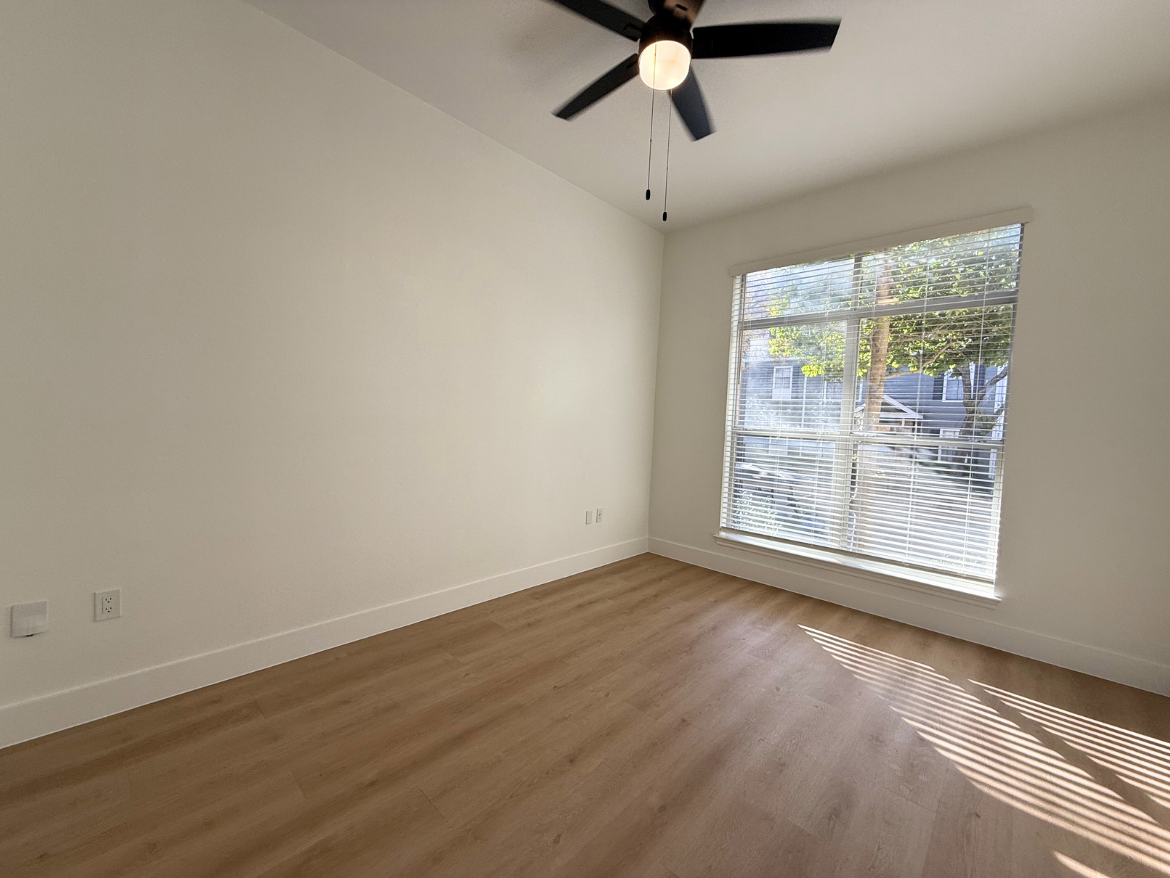 The Colony apartment bedroom with wood-style flooring